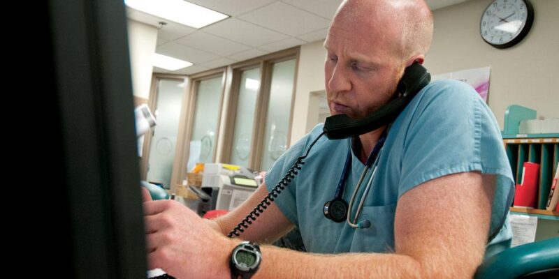 Eric Shaw on phone giving telemedicine